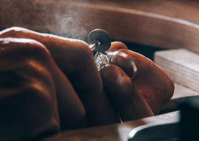 Jeweler polishing a ring